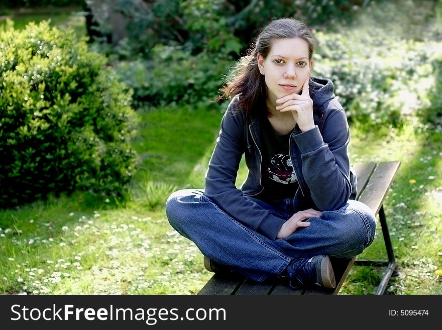 Woman sitting on a bench in the nature. Woman sitting on a bench in the nature