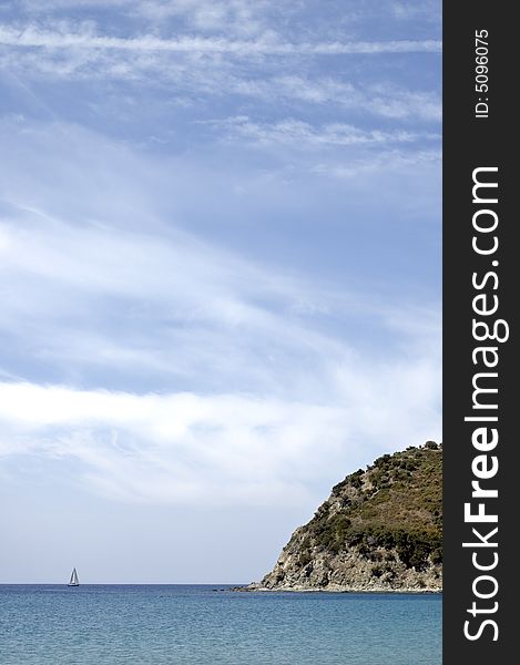 A little boat and a typical mediterranean landscape. Vertical composition. A little boat and a typical mediterranean landscape. Vertical composition