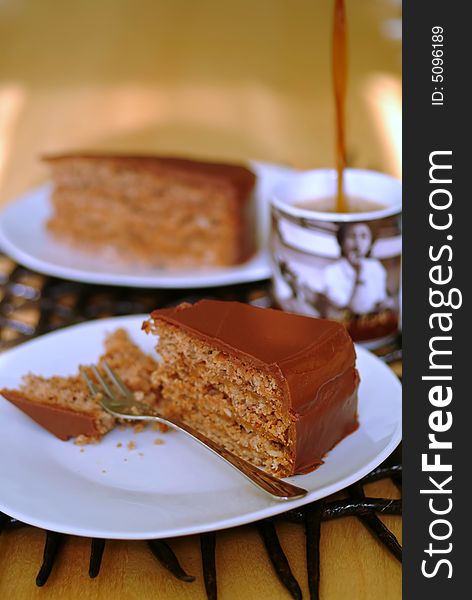 Chocolate cake and coffee being poured into mug