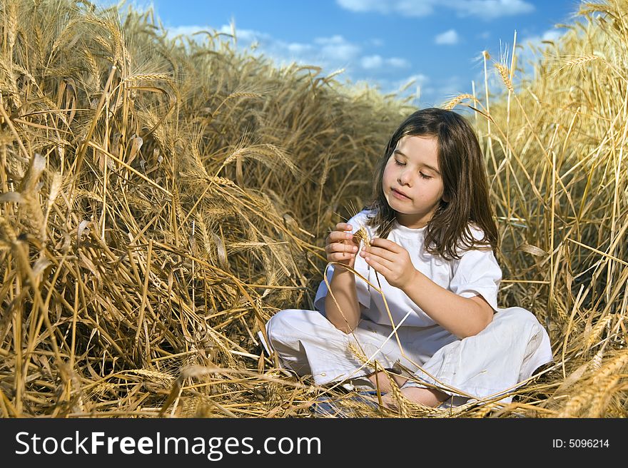Littel girl in a wheat field