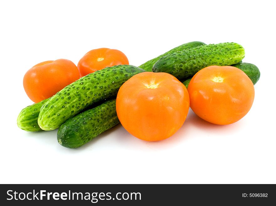 Tomatoes and cucumbers isolated on white