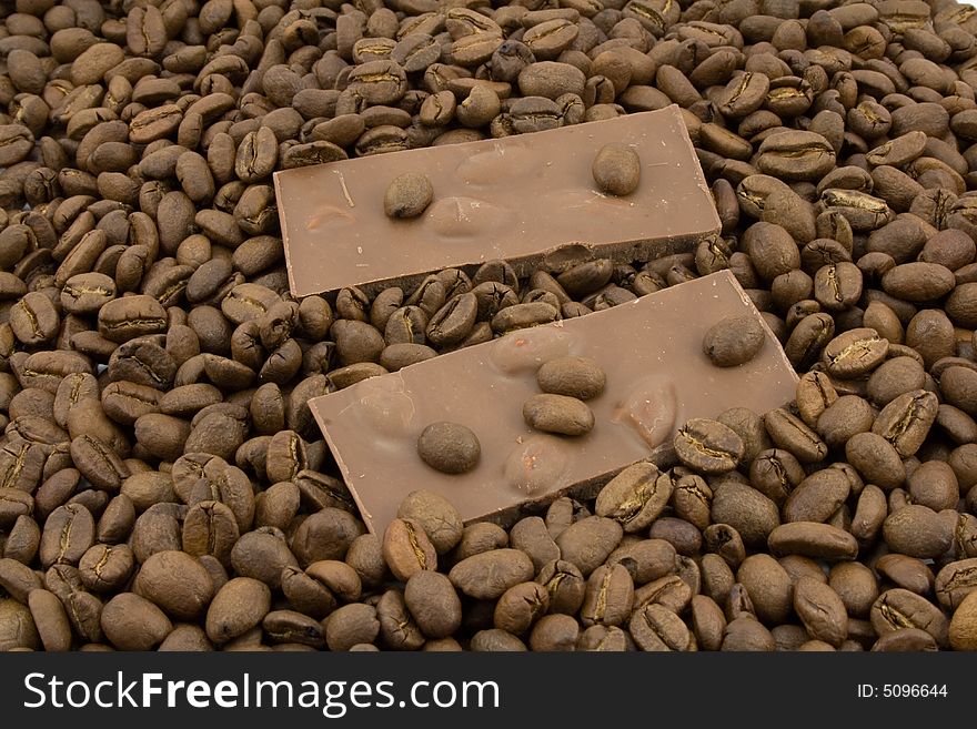 Chocolate and coffee beans isolated on white. Chocolate and coffee beans isolated on white