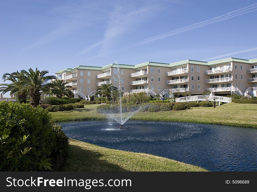 A nice luxury condo complex on the beach with a lake and fountain. A nice luxury condo complex on the beach with a lake and fountain