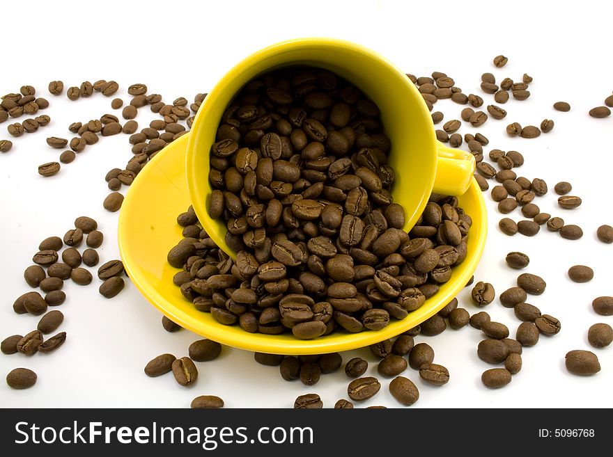 Cup with coffee beans isolated on white. Cup with coffee beans isolated on white