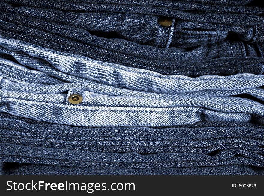 Close-up of a stack of folded blue jeans.