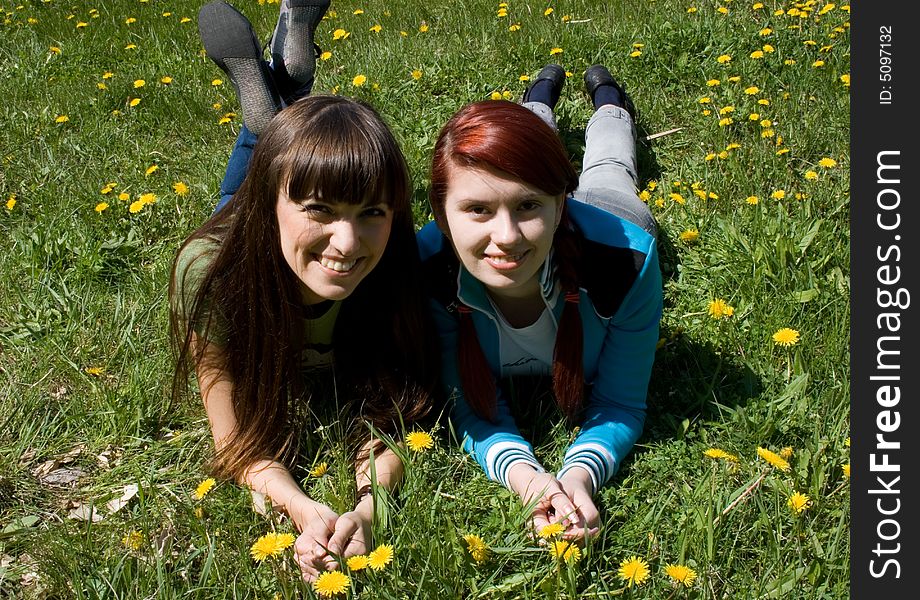 Two beautiful girls laying on meadow. Two beautiful girls laying on meadow