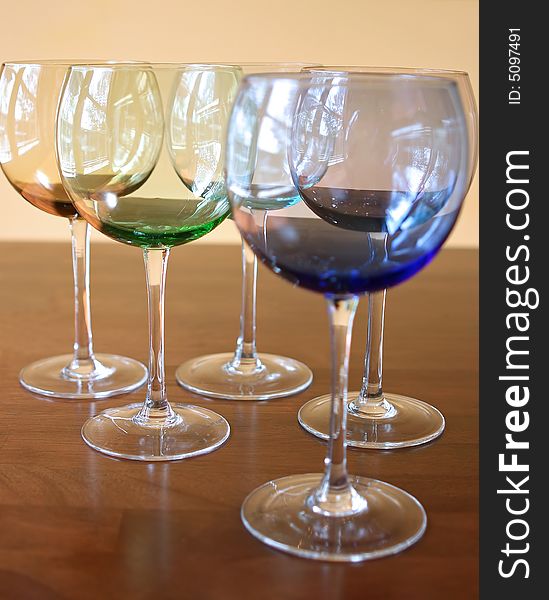 Different colored wine glasses with a simple background