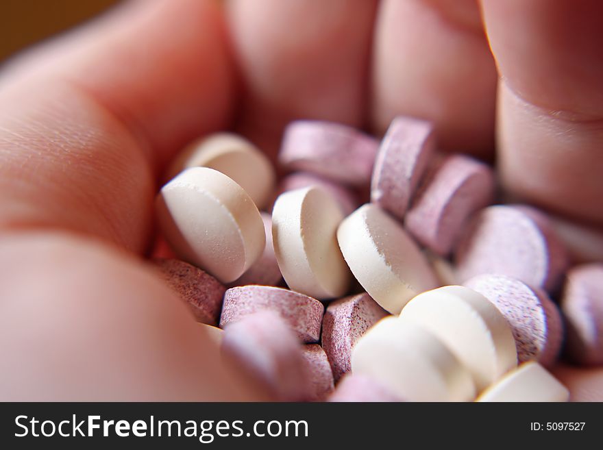 Close up of various pills in the palm of a hand. Close up of various pills in the palm of a hand