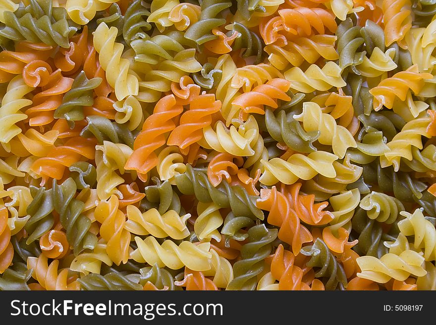 Dry multicolour pasta with tomato and spinach