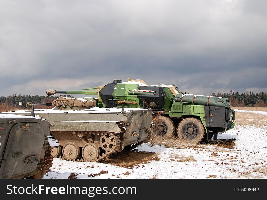 Three military vehicles are guarding territory against the enemy. Three military vehicles are guarding territory against the enemy