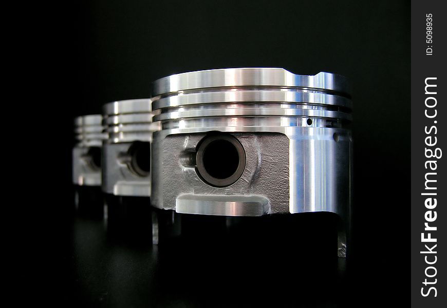 Pistons without rings on back background. Pistons without rings on back background