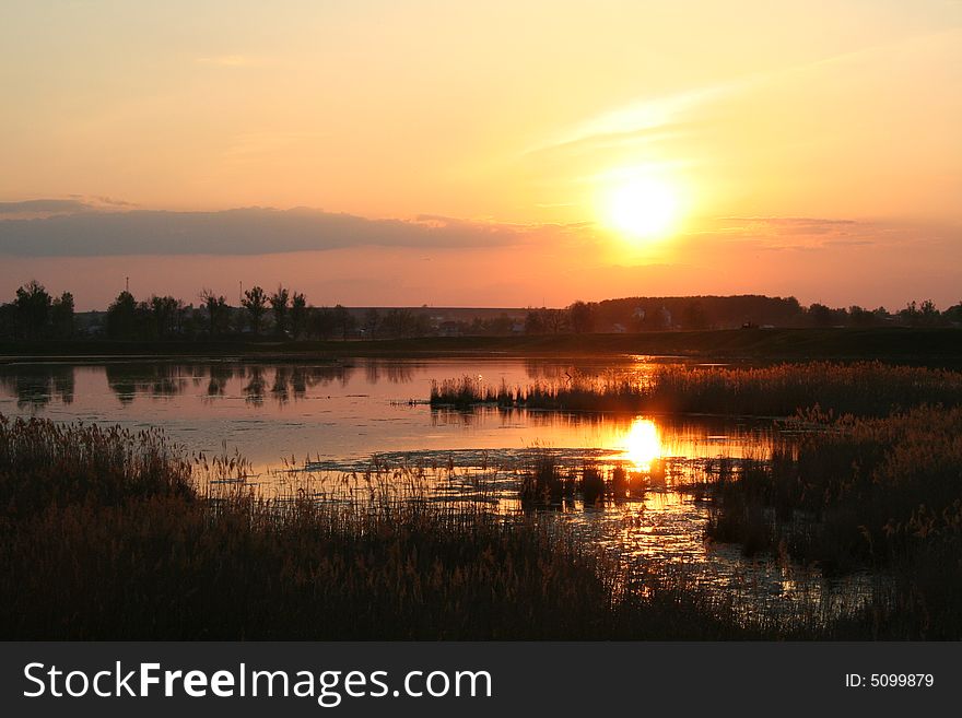 Sunset on the lake with lake silhouette