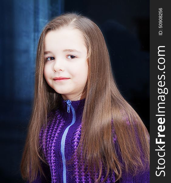 Portrait of a pretty little girl near the window