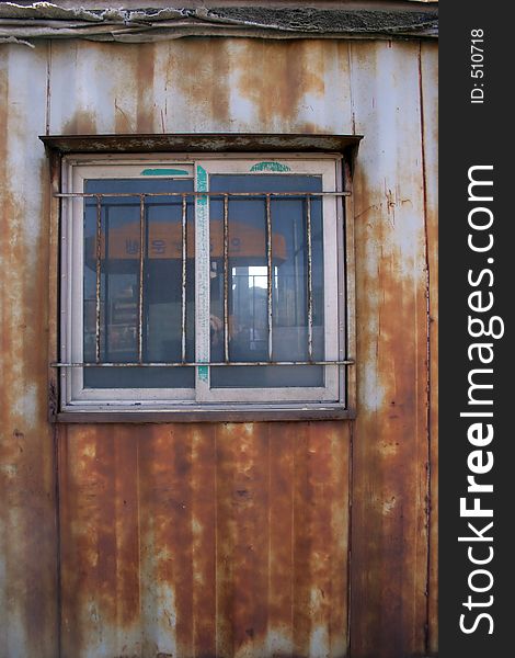 Window on a rusty old iron building. Window on a rusty old iron building