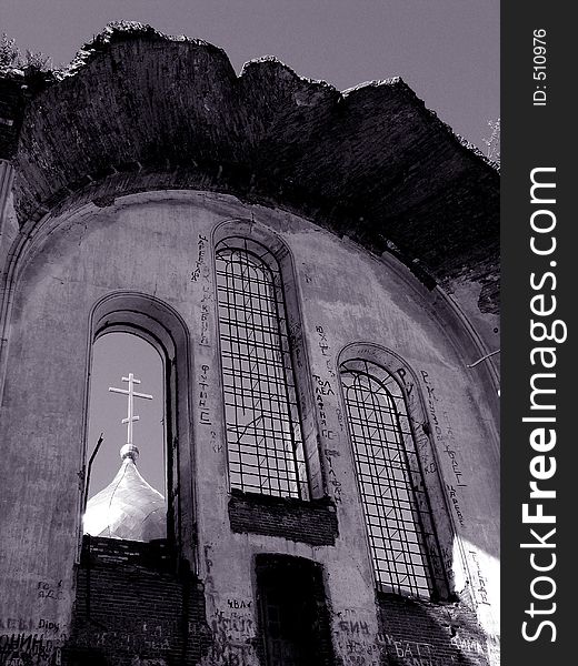 The ruinous church in Nizhni Nnovgorod region, Russia. In the nearest window-frame you can see a cupola of the new building. The ruinous church in Nizhni Nnovgorod region, Russia. In the nearest window-frame you can see a cupola of the new building.