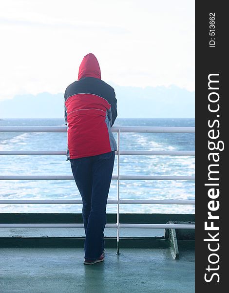 Alone Man In The Hood Standing At The Ferry And Looking At The Sea