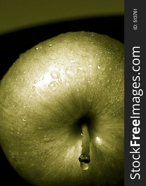 Green apples against a black background. Green apples against a black background