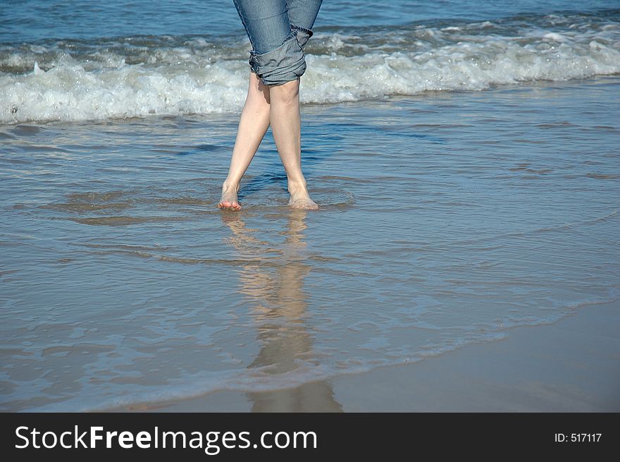 Crossed legs on the summer beach. Crossed legs on the summer beach.