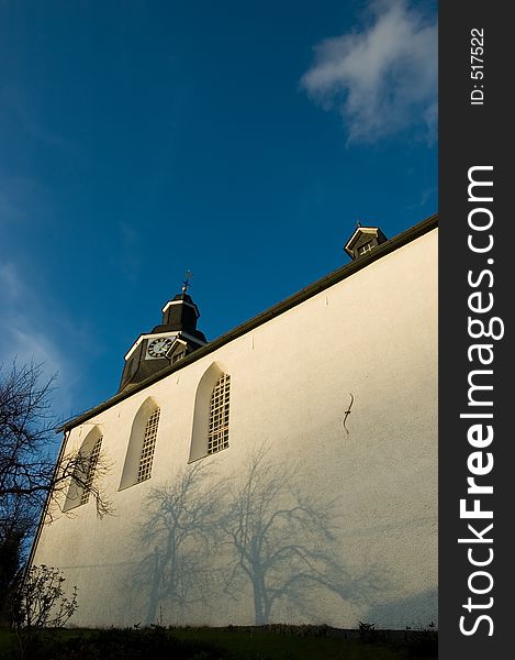 A church with shadow on the wall.