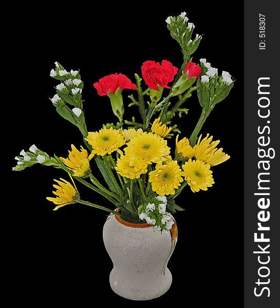 A welcome bouquet of flowers in a vase, isolated on black