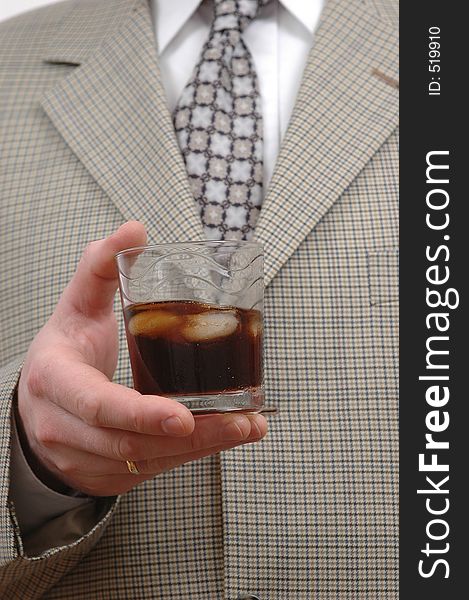 Businessman celebrating something with a glass of drink. Businessman celebrating something with a glass of drink