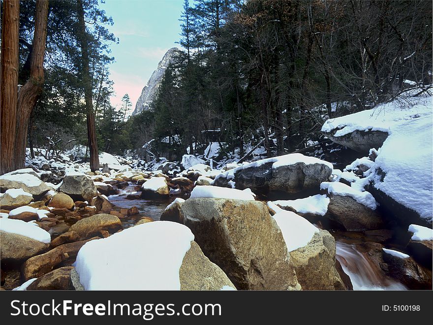 A cold frozen winter river flowing through Yosemite National Park. A cold frozen winter river flowing through Yosemite National Park