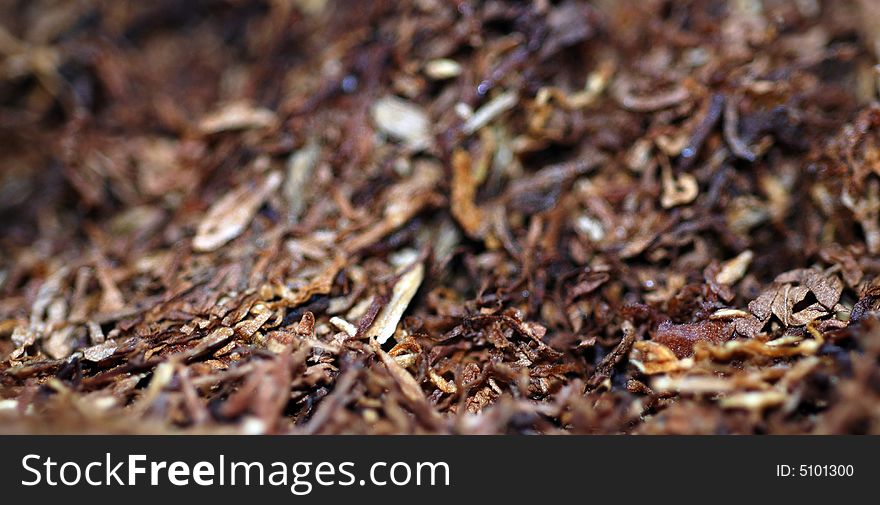 A macro shot of tobacco, ready to roll into a cigarette