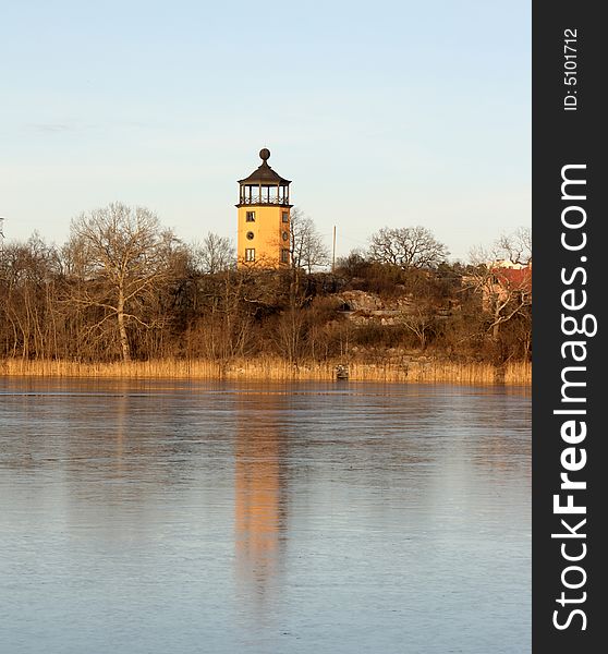 Lighthouse in the winter waiting for darkness to serve