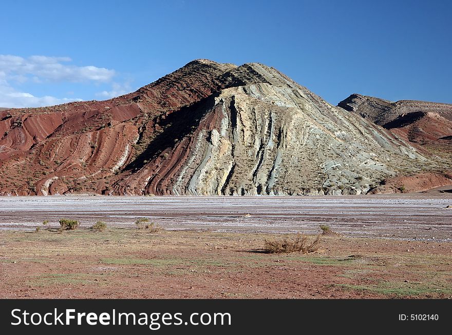 Geological feature of a hill with colorful purple gravel. Altiplano. Bolivia. Geological feature of a hill with colorful purple gravel. Altiplano. Bolivia.