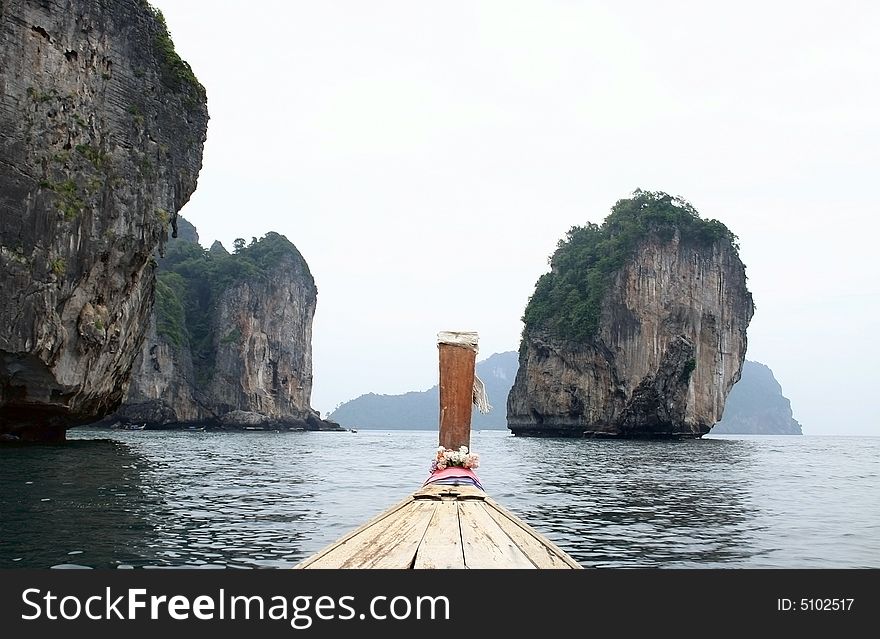 View from traditional Thai Boat on cliff rocks in Krabi. Thailand