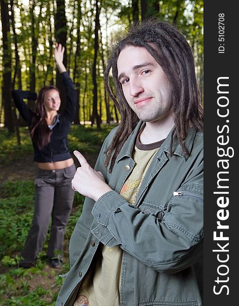 Young man with dreadlocks and girl in a forest. Young man with dreadlocks and girl in a forest