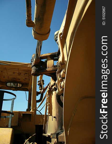 View of yellow construction truck from behind. View of yellow construction truck from behind