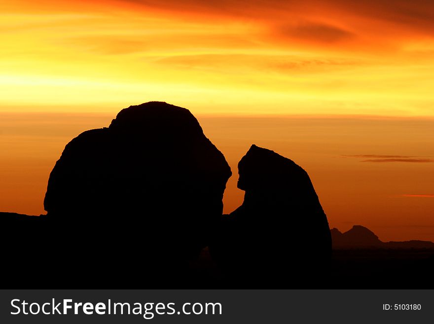 Silhouettes of Spitzkoppe rocks at colorful sunset scene. Namibia. Africa