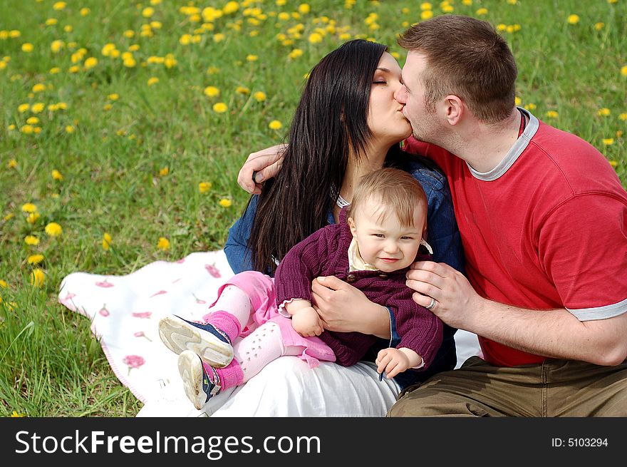 Happy family together on green meadow