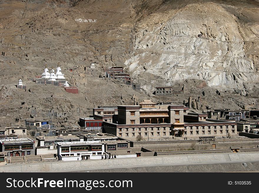 Buddist monastery - Tibetan stupas above the village in mountains. Tibet