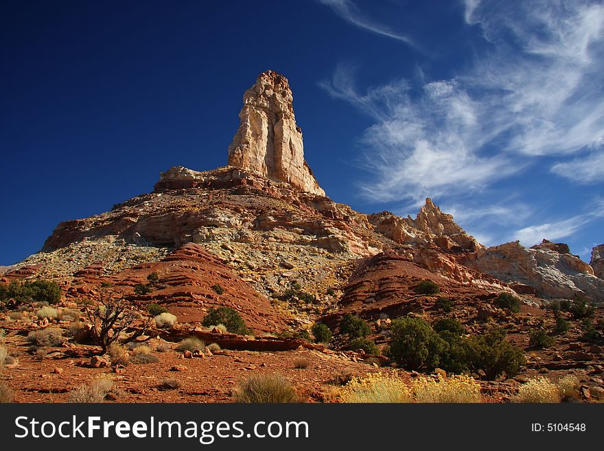 View of the red rock formations in San Rafael Swell with blue skyï¿½s and clouds. View of the red rock formations in San Rafael Swell with blue skyï¿½s and clouds