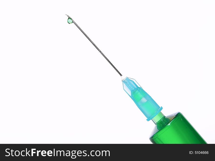A syringe with green fluid inside