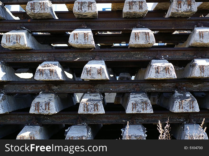 Concrete bars with railways in a pile at a construction site