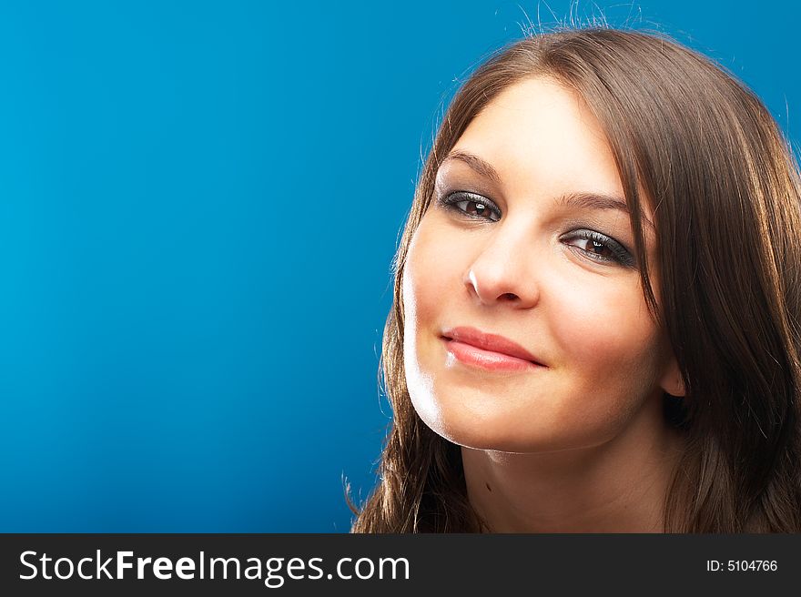 Beautiful Fashion Model shot in studio over blue background