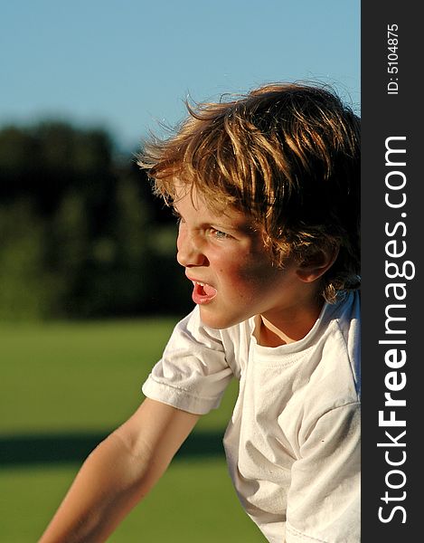 Close-up candid portrait of boy playing sport at park. Close-up candid portrait of boy playing sport at park