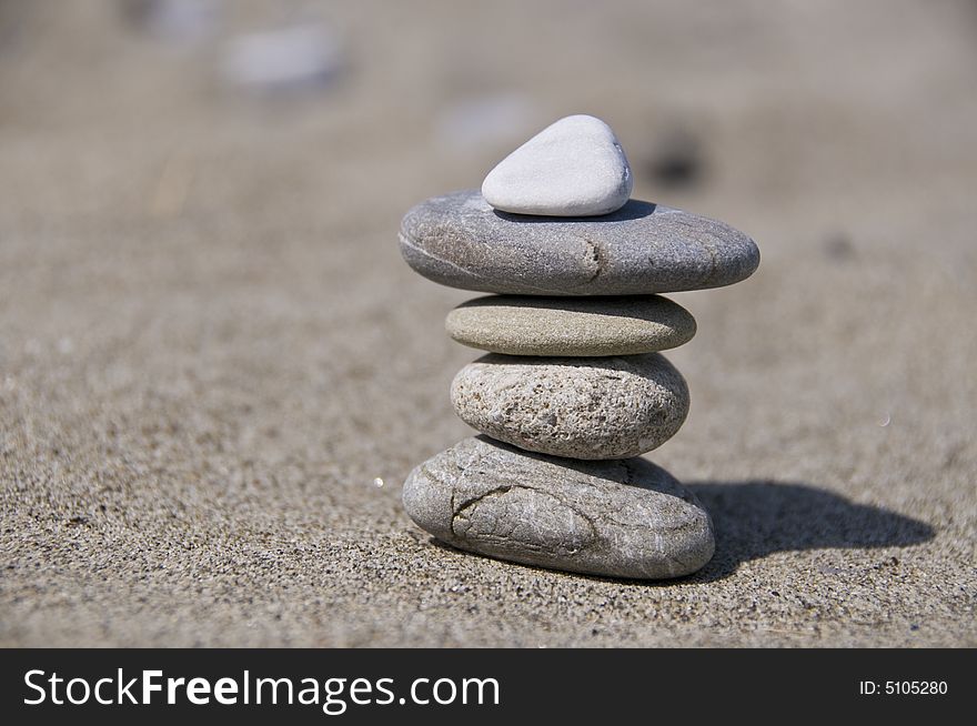 Balancing stone and sand background