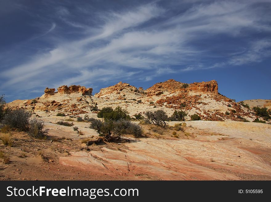 View of the red rock formations in San Rafael Swell with blue skyï¿½s and clouds. View of the red rock formations in San Rafael Swell with blue skyï¿½s and clouds