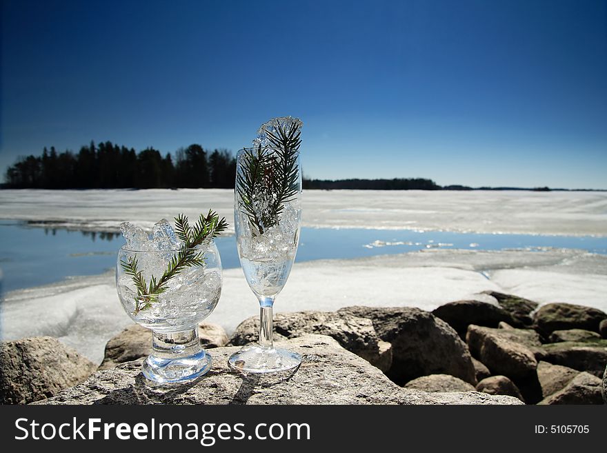 Glasses with ice on the edge of a frozen lake