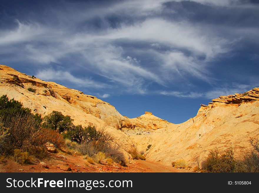 View of the red rock formations in San Rafael Swell with blue skyï¿½s and clouds. View of the red rock formations in San Rafael Swell with blue skyï¿½s and clouds