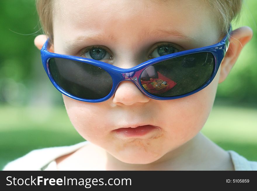 A cool little boy with sunglasses. A cool little boy with sunglasses