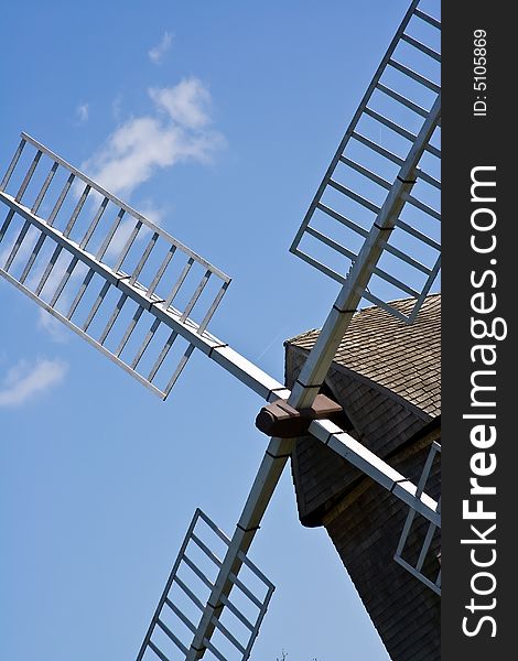 Old windmill against a blue sky nice green background image. Old windmill against a blue sky nice green background image