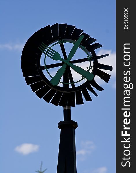 Old windmill against a blue sky nice green background image. Old windmill against a blue sky nice green background image