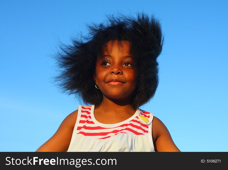 Young girl in the wind with hair blowing around.