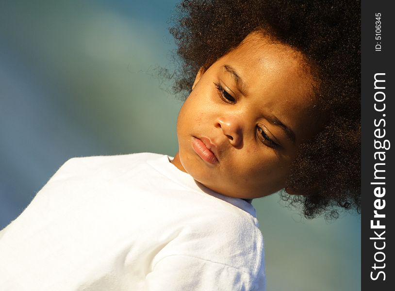 Young child looking downward. Image angled for abstract effect. Young child looking downward. Image angled for abstract effect.