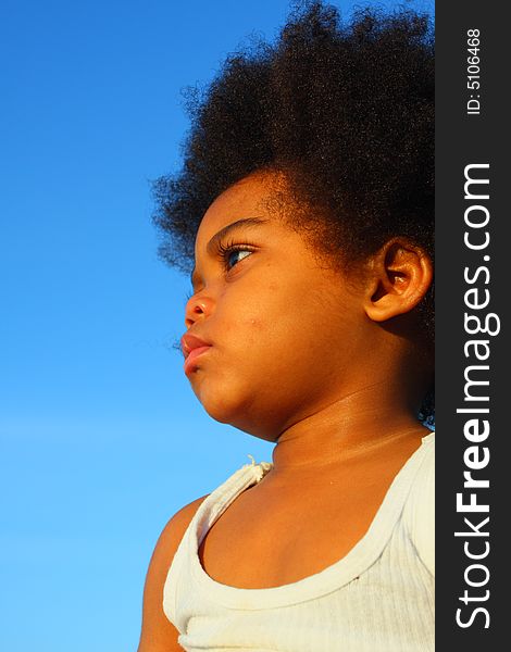 Young child with a blue sky background which could be used for copyspace. Young child with a blue sky background which could be used for copyspace.